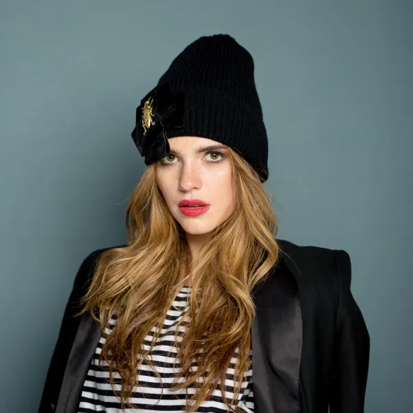 Czarna czapka premium z kokardą i złotym robakiem.