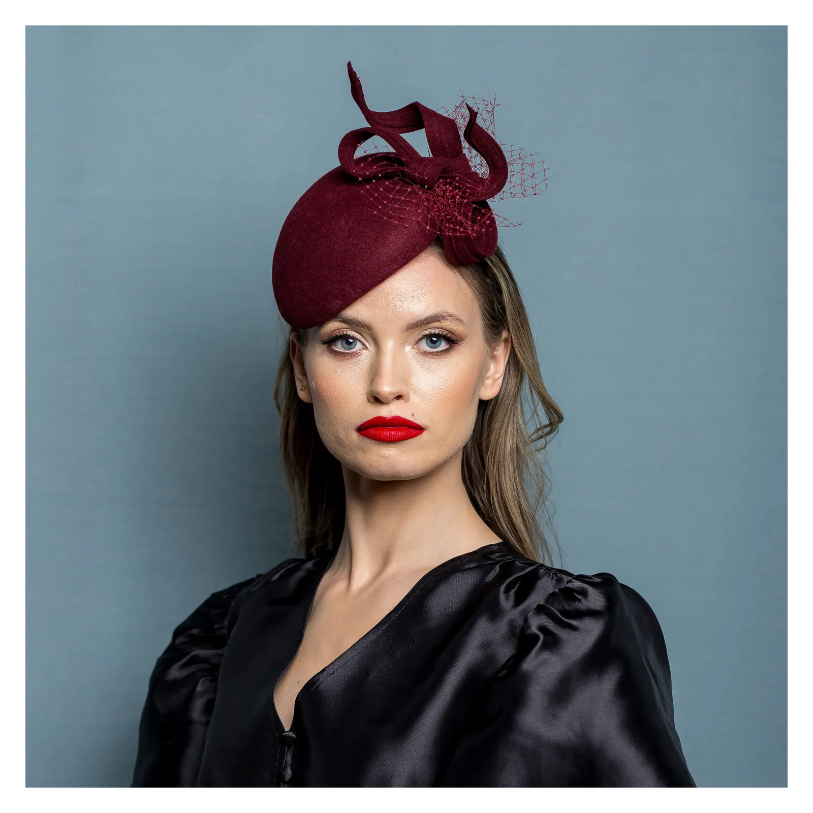 Ozdobne nakrycie głowy- mały burgundowy kapelusz.