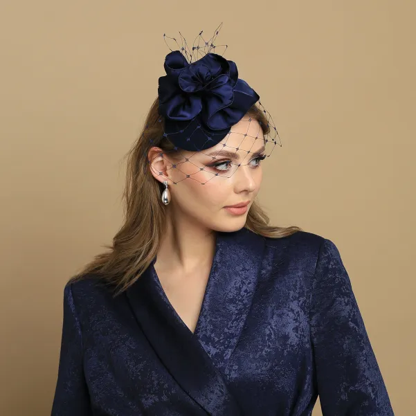 Granatowy mini toczek-fascynator z nieoczywistym kwiatem i woalką.