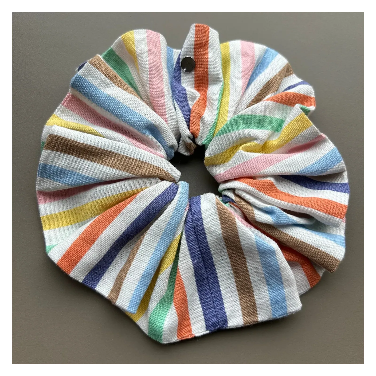 Duża gumka do włosów w kolorowe paseczki.