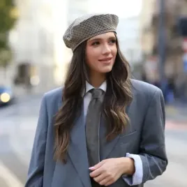 Stylowy beret w brązowo-beżową kratkę.