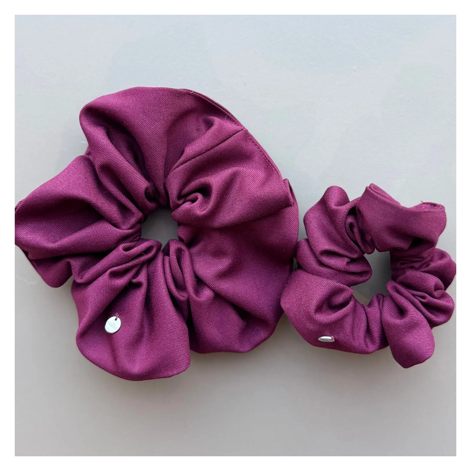 Duża burgundowa gumka do włosów.